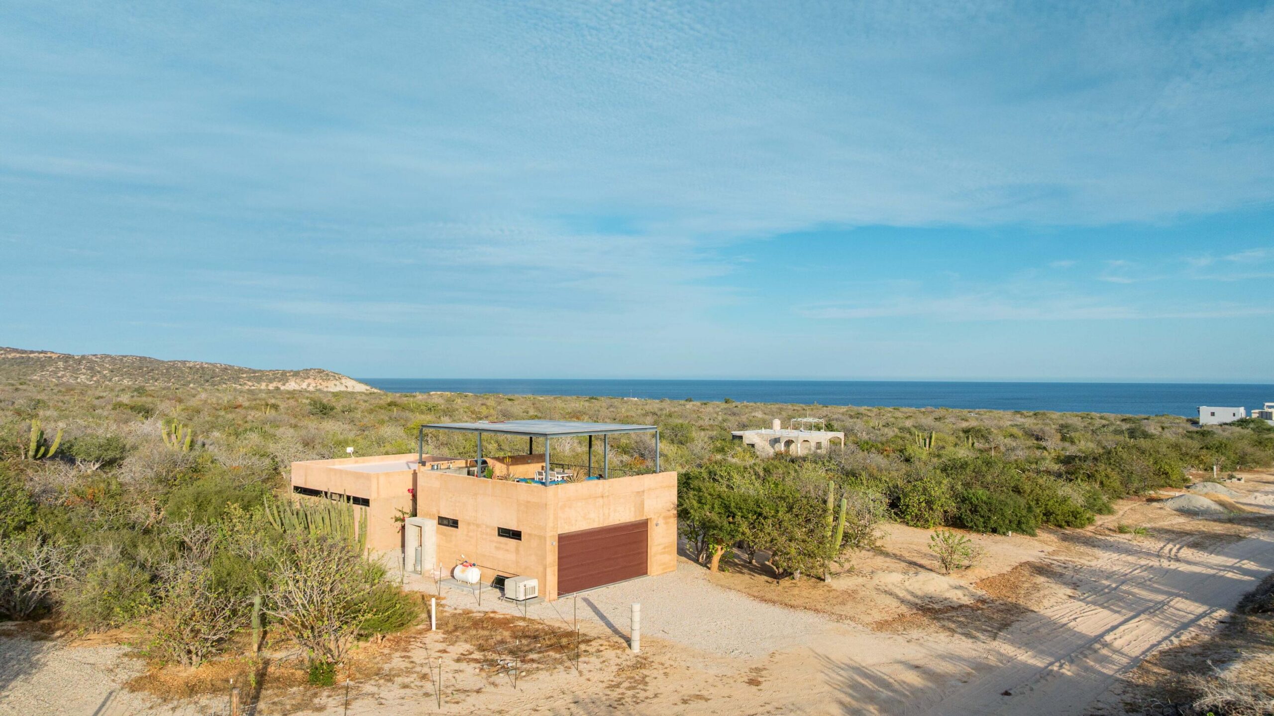 Cabo San Lucas Lomas Del Faro Casa en venta en Lomas del Faro Viejo, Los Cabos, con 225 m² de terreno y 130 m² de construcción distribuidos en dos niveles. La propiedad cuenta con amplia área de sala y comedor, cocina equipada con isla central y medio baño para visitas. En el exterior ofrece cochera para un vehículo, terraza, jardín y área de lavado de gran tamaño con pasto sintético.En planta baja se encuentran dos recámaras, cada una con clóset y baño completo privado, además de un espacio ideal para sala de televisión o área familiar. En la planta alta se ubica la recámara principal, que cuenta con clóset, baño completo, área de estudio y acceso a una terraza privada.La vivienda dispone de cisterna con capacidad de 10,000 litros y ofrece espacios amplios, funcionales y modernos. for sale